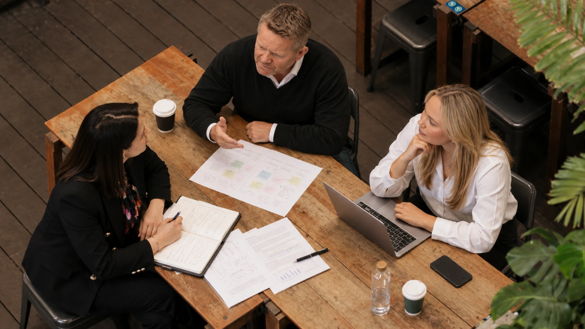 Deca People consultants working through a hiring plan at a table