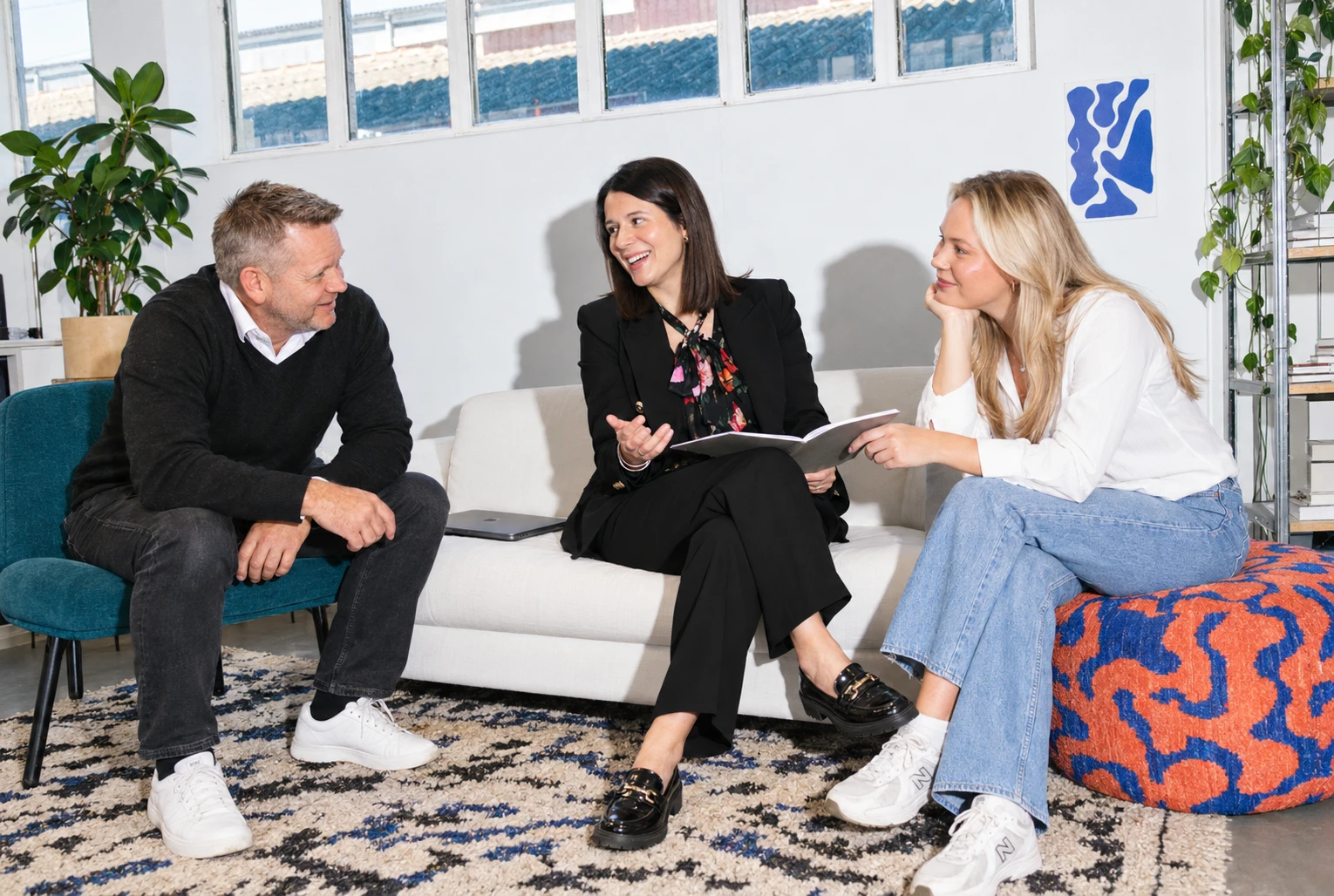 Deca People team talking on a sofa in the office